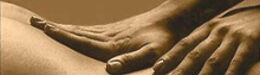 Sepia photograph of hands touching a lower back