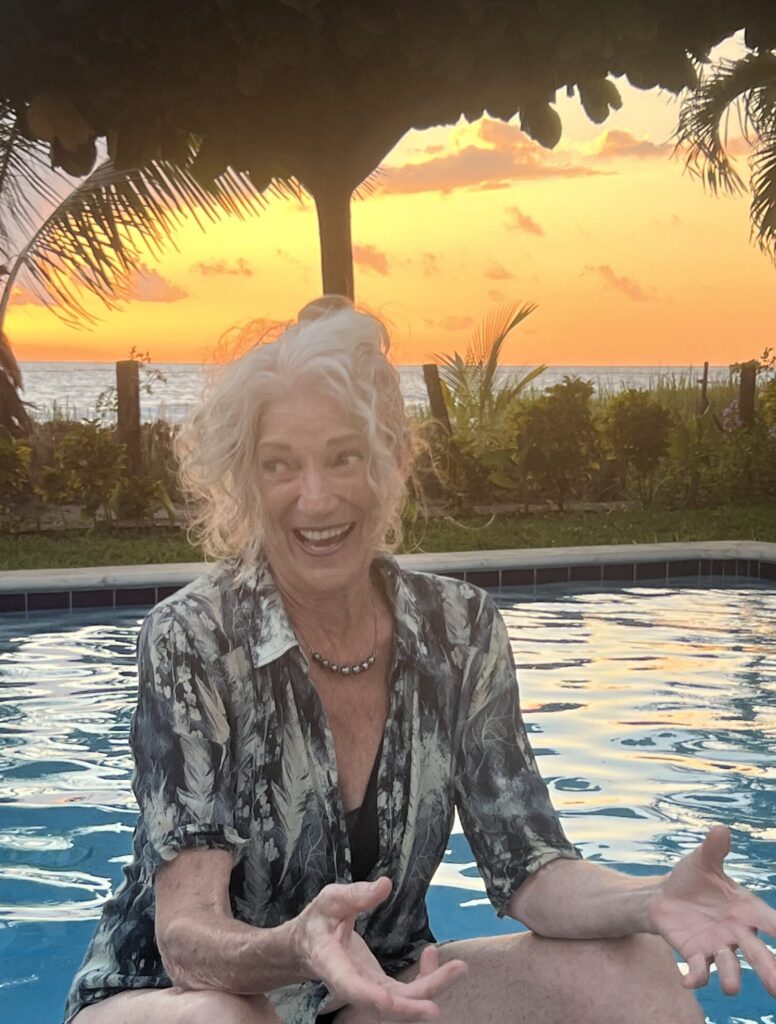 Photo of Charla Hathaway teaching by a pool at sunset in a tropical location